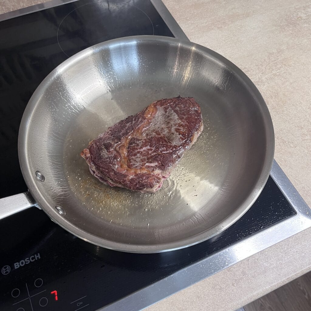Cooking steak on a stainless steel pan