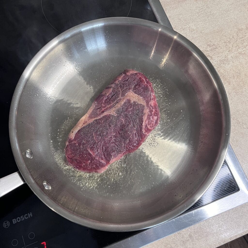 Steak on a stainless steel pan