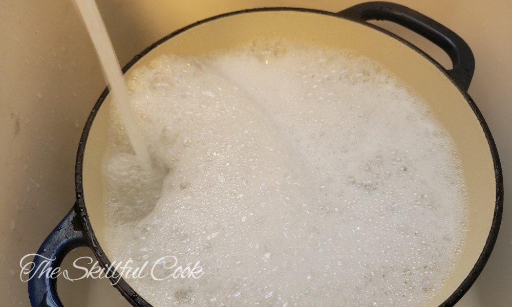 how to clean enameled cast iron - Fill the pot with hot water