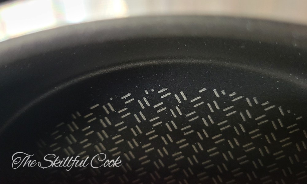 Titanium particles extend slightly above the nonstick coating
