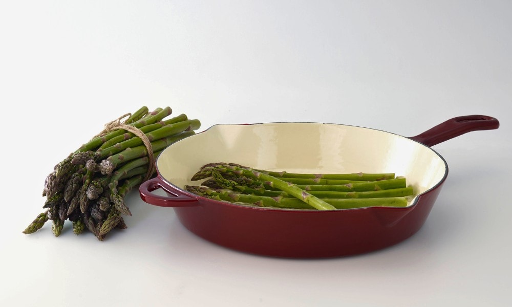enameled cast iron frying pan with asparagus