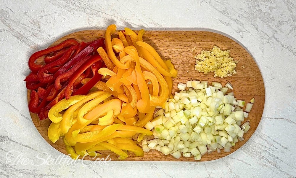 Slice the onions and bell peppers into thin half-moon slices